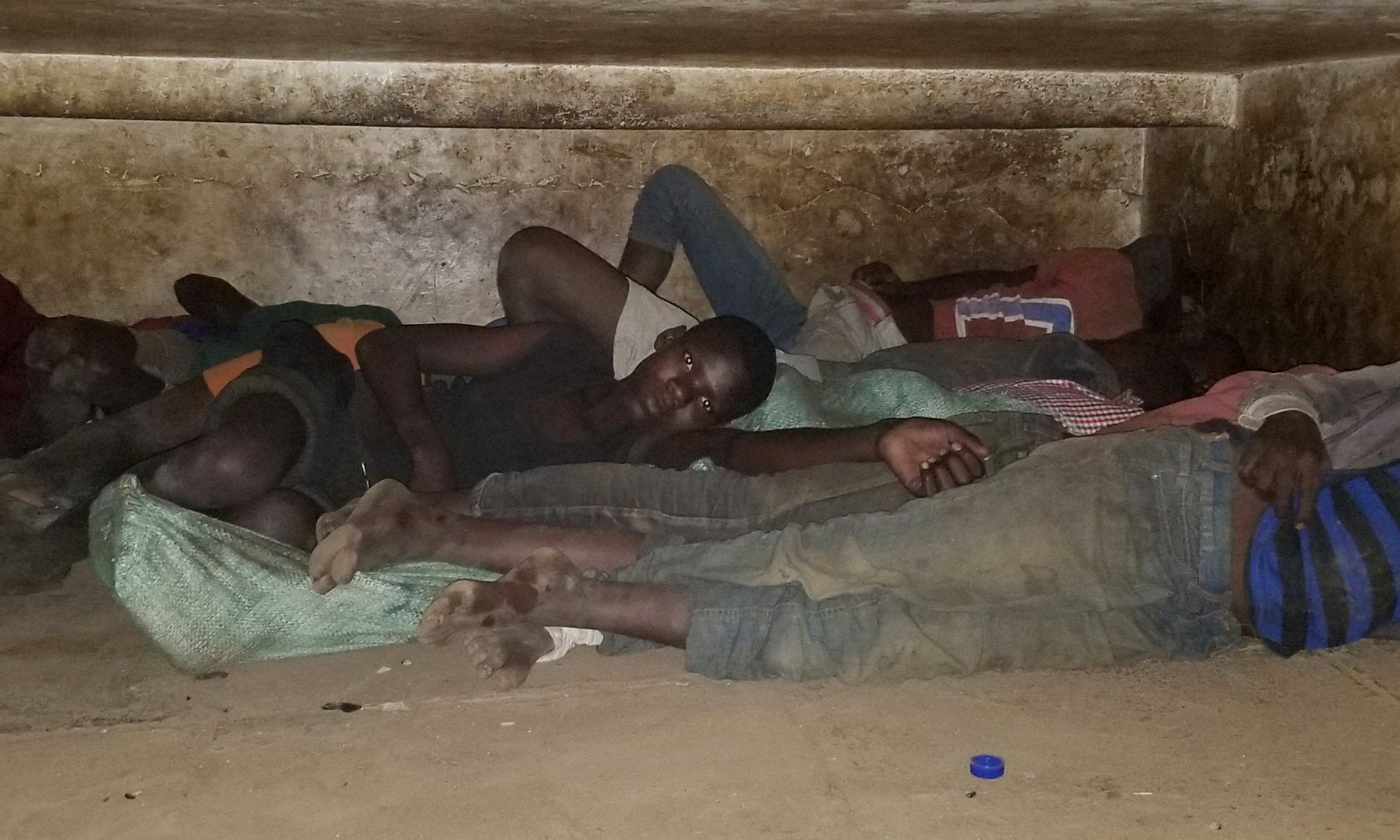 Boys sleeping under the street in Kisenyi, Kampala, Uganda.
