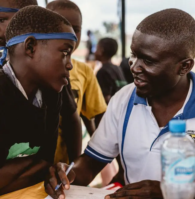 A man and boy are talking to each other.