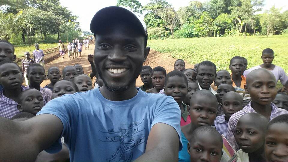 A man taking a selfie with a group of people.