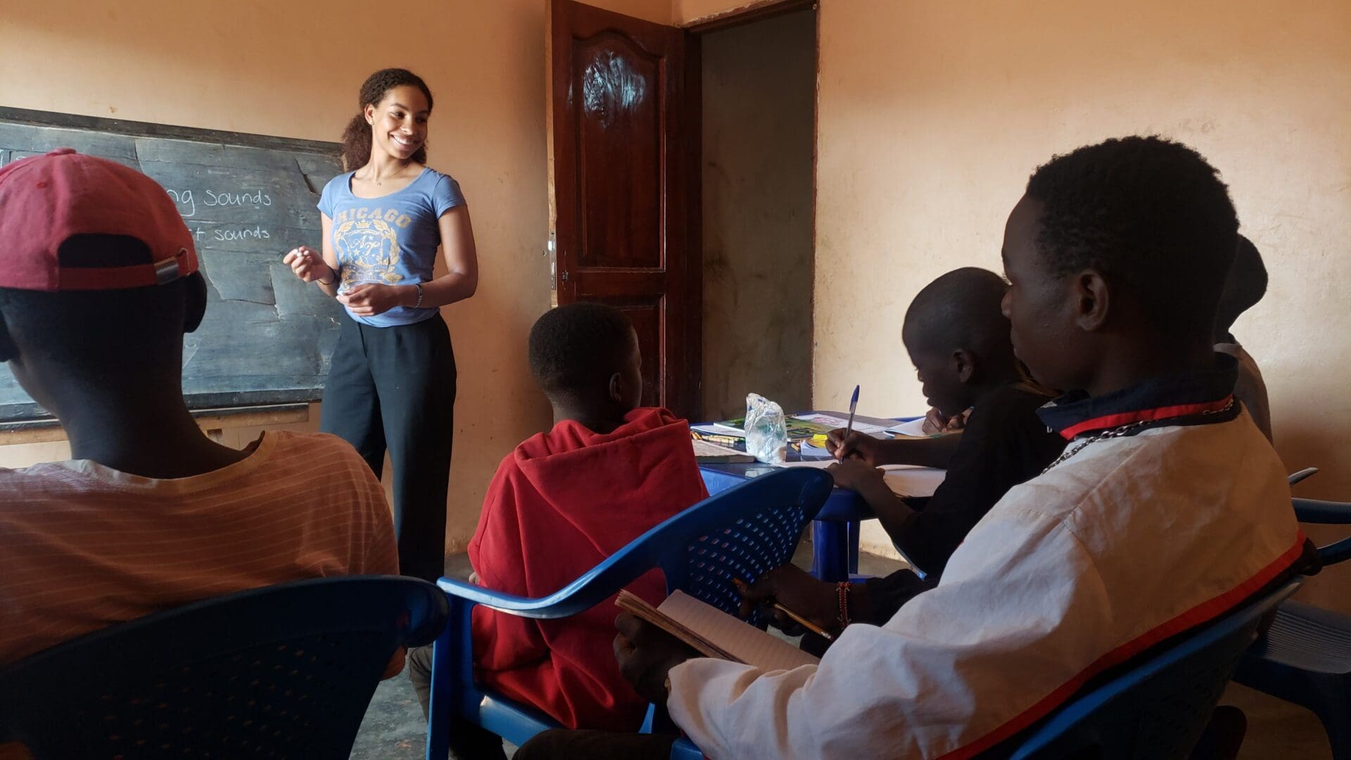 A woman standing in front of some people.