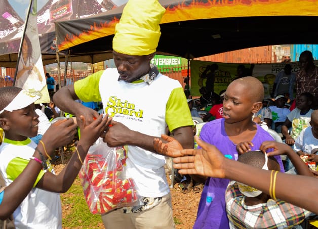 A man in yellow shirt holding up his hands.