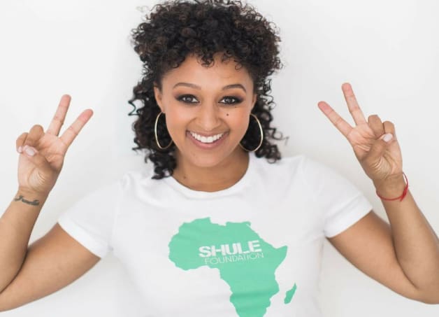 A woman in white shirt with green lettering