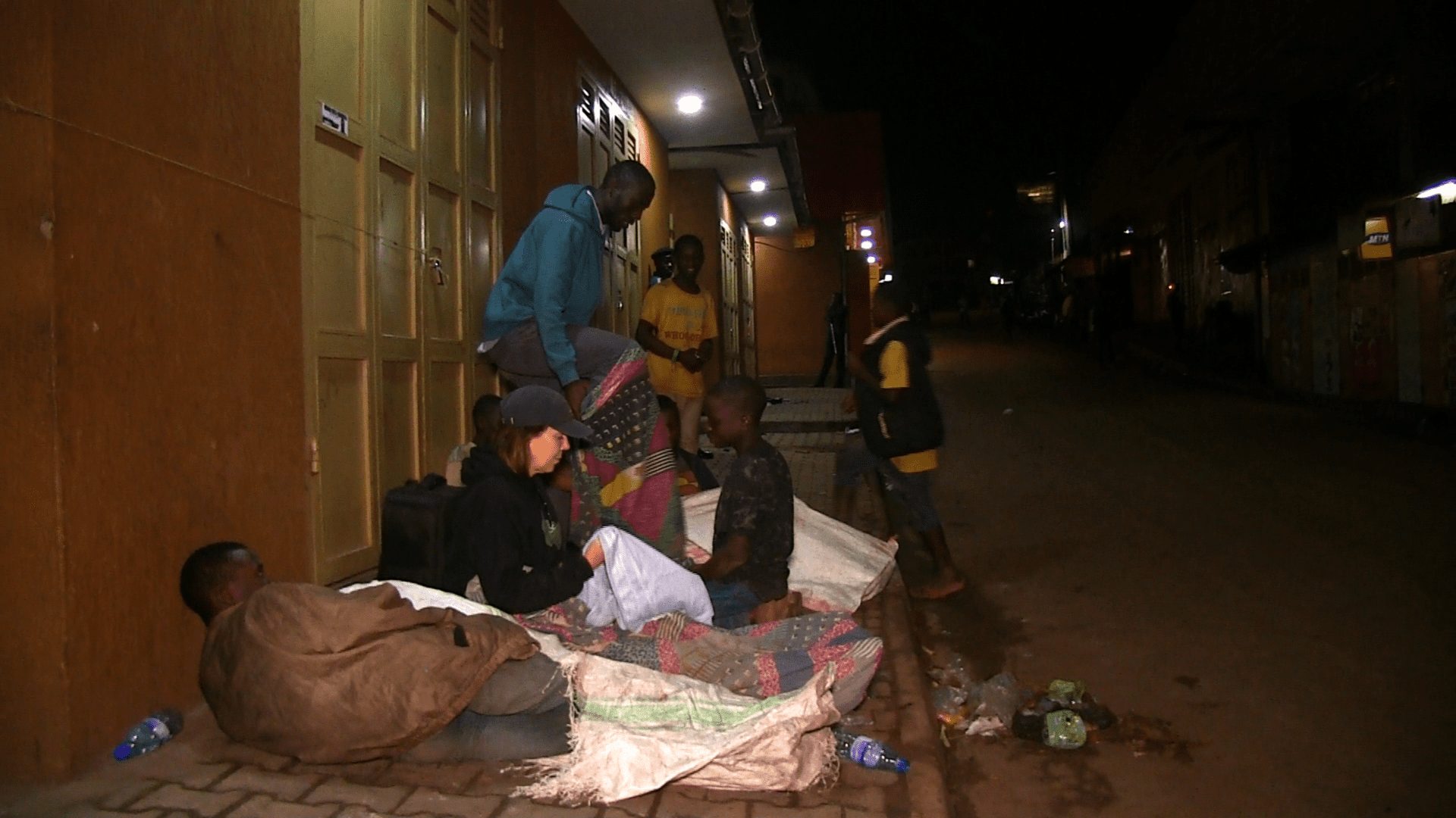 A group of people sitting on the ground.