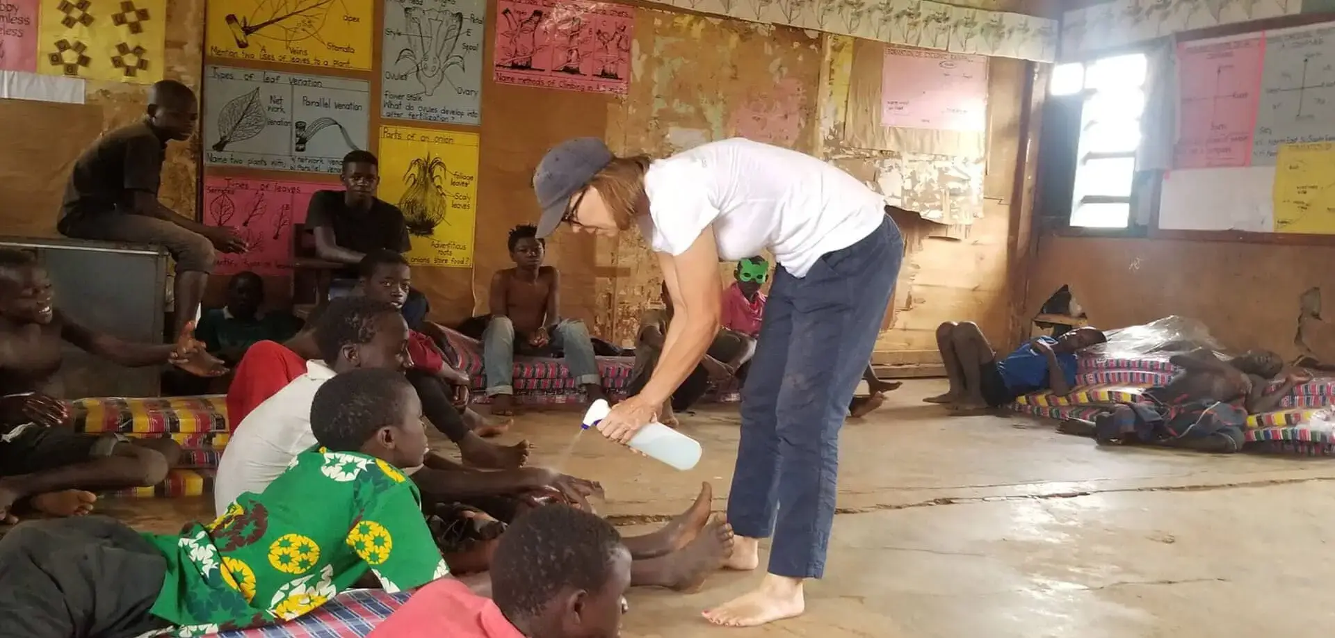 Woman helping children in a classroom.